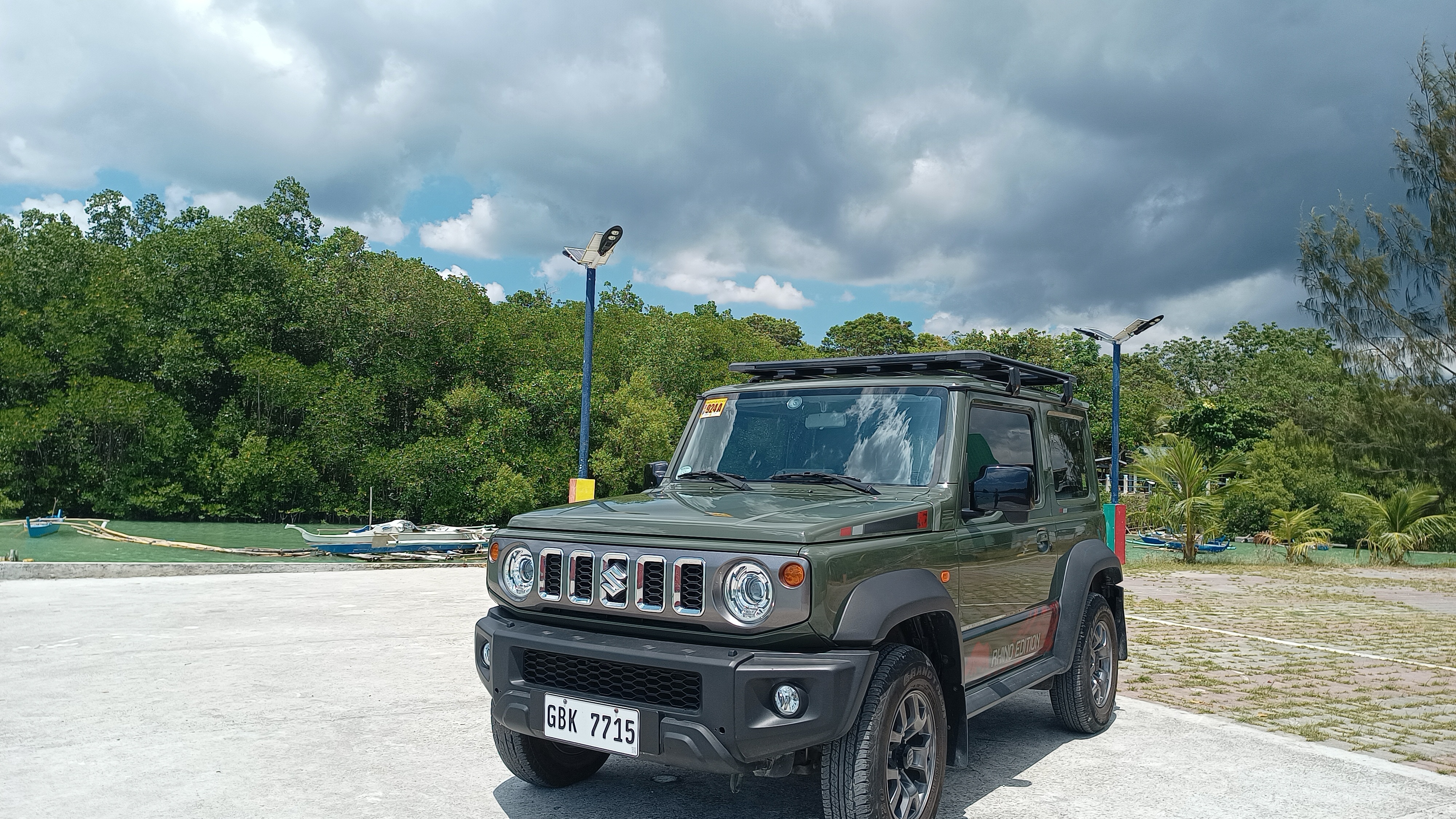 Jimny against mangroves under stormy sky
